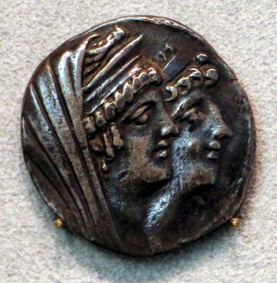 Ancient Ptolemaic coin with royal profiles photograph