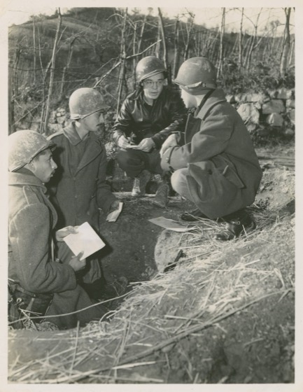 11 Dec 1944. BEF/5/MM-44-31385. Fifth Army, Italy. Robert Vermillion, United Press war correspondent (in leather jacket), gets front-line interview from Brazilian infantrymen in their fox-holes. L-R: Pvt. Edgar Vasques Rodriges, and Pvt. Maria Feliciano Gauza, both from Rio de Janiero. At right is B