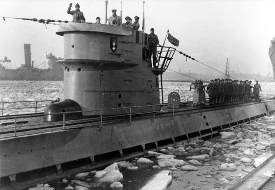 A German type IX submarine docking at Tromsø, Norway, during World War II. It is known that two Type IX submarines used an emblem of two crosses with a crown above: U-108, U-864. Type VIIC submarines U-431 and U-1209 also used such an emblem. It is not known, if either boat ever visited Tromsø. U-10